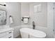 Bright bathroom featuring a soaking tub with sleek black fixtures at 1053 Snow Lily Ct, Castle Pines, CO 80108