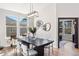 Bright dining area featuring large windows, modern lighting, and a stylish table setup, perfect for Gathering meals and entertaining guests at 1053 Snow Lily Ct, Castle Pines, CO 80108