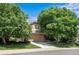 Charming two-story home featuring a well-maintained yard and mature trees at 1053 Snow Lily Ct, Castle Pines, CO 80108