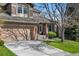 Beautiful home featuring a brick-accented front, well-maintained lawn, and an inviting entrance at 1053 Snow Lily Ct, Castle Pines, CO 80108