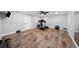 Home gym featuring wood-look floors, exercise equipment, and neutral walls at 1053 Snow Lily Ct, Castle Pines, CO 80108