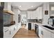 Modern kitchen with white cabinets, stainless steel appliances, and hardwood flooring at 1053 Snow Lily Ct, Castle Pines, CO 80108