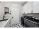 Modern laundry room featuring new washer and dryer units and convenient sink at 1053 Snow Lily Ct, Castle Pines, CO 80108