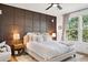 Inviting primary bedroom featuring a cozy sitting area, large windows, and a calming color scheme at 1053 Snow Lily Ct, Castle Pines, CO 80108