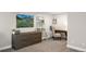 Basement office featuring dark-stained writing desk, drawers, and mountain-themed artwork at 1053 Snow Lily Ct, Castle Pines, CO 80108