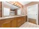 Bathroom with dual vanity, wood cabinets, and a tile shower with a glass door at 2960 Inca St # 308, Denver, CO 80202