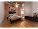 Cozy bedroom showcases exposed brick wall, hardwood floors, and ample closet space at 2960 Inca St # 308, Denver, CO 80202