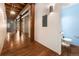 Open concept hallway featuring hardwood floors, exposed ductwork, and bathroom at 2960 Inca St # 308, Denver, CO 80202
