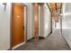 Hallway view with unit number, wooden support beam and access to other units at 2960 Inca St # 308, Denver, CO 80202