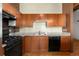 Efficient kitchen with ample cabinetry, stone counters, and modern black appliances at 2960 Inca St # 308, Denver, CO 80202