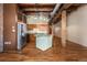 Open kitchen features stainless steel appliances, wooden cabinets, and a center island at 2960 Inca St # 308, Denver, CO 80202