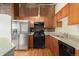 Well-equipped kitchen featuring stainless steel refrigerator and gas range with ample counterspace at 2960 Inca St # 308, Denver, CO 80202