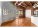 Bright, open living room featuring exposed brick, concrete walls, and hardwood floors at 2960 Inca St # 308, Denver, CO 80202