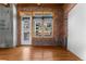 Bright living room has hardwood floors, and exposed brick near the sliding glass door at 2960 Inca St # 308, Denver, CO 80202