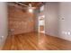 Hardwood floors with a brick accent wall, and an adjacent room with oak cabinets at 2960 Inca St # 308, Denver, CO 80202
