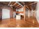 Spacious living space with hardwood floors and exposed brick, leading into an open kitchen at 2960 Inca St # 308, Denver, CO 80202