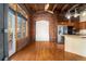 Open living space features exposed brick walls, hardwood floors, and a modern kitchen at 2960 Inca St # 308, Denver, CO 80202