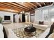Partially finished basement with exposed beams, painted walls, and carpeted area at 7765 S Curtice Dr # A, Littleton, CO 80120