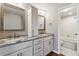 Bright bathroom features double sinks, granite countertops, and a classic white cabinet at 7765 S Curtice Dr # A, Littleton, CO 80120