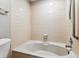Bathroom features a corner bathtub with neutral tile surround at 7765 S Curtice Dr # A, Littleton, CO 80120