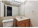 Simple basement bathroom with single sink vanity and toilet at 7765 S Curtice Dr # A, Littleton, CO 80120