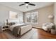 Comfortable bedroom with hardwood floors, ceiling fan, and natural light at 7765 S Curtice Dr # A, Littleton, CO 80120