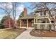 Charming townhouse with brick chimney, covered entryway, and established landscaping at 7765 S Curtice Dr # A, Littleton, CO 80120