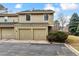 Two-car garage and neutral exterior provide an inviting curb appeal for this home at 7765 S Curtice Dr # A, Littleton, CO 80120