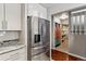 Kitchen with stainless steel refrigerator, granite countertops, and custom cabinetry at 7765 S Curtice Dr # A, Littleton, CO 80120