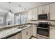 Updated kitchen with granite countertops and stainless steel appliances at 7765 S Curtice Dr # A, Littleton, CO 80120