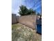 View of fenced backyard area with grass and gravel and a blue trash container at 1132 Moline St, Aurora, CO 80010