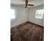 Well-lit bedroom featuring a ceiling fan and two windows at 1132 Moline St, Aurora, CO 80010