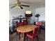 Inviting dining area with a wooden table, red chairs, and ample shelving for storage at 1132 Moline St, Aurora, CO 80010