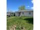 Modest one-story home on a sunny day, showcasing its simple charm and spacious front yard at 1132 Moline St, Aurora, CO 80010