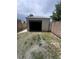 View of detached garage with open door surrounded by gravel at 1132 Moline St, Aurora, CO 80010