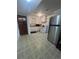 Functional kitchen with stainless steel refrigerator, ample cabinet space and patterned flooring at 1132 Moline St, Aurora, CO 80010