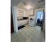 Efficient kitchen with white cabinets, appliances, and updated flooring at 1132 Moline St, Aurora, CO 80010