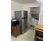 Functional kitchen with stainless steel refrigerator and a view into a laundry area for added convenience at 1132 Moline St, Aurora, CO 80010