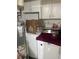 Practical laundry area with modern washer and dryer, featuring storage shelves and updated utilities at 1132 Moline St, Aurora, CO 80010