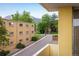 Balcony view overlooking the street, the neighborhood, and with trees and a mountain in the distance at 850 20Th St # 203, Boulder, CO 80302