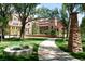 Campus building with red brick and arched windows, next to a walkway and landscaped lawn at 850 20Th St # 203, Boulder, CO 80302