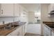 Well-lit kitchen with stainless steel sink, plenty of cabinet space, and an open view to the living room at 850 20Th St # 203, Boulder, CO 80302