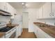 Functional kitchen featuring white appliances and cabinets, with earth-toned countertops and flooring at 850 20Th St # 203, Boulder, CO 80302