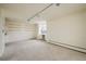 Open living area with wall-mounted shelves, modern track lighting and large windows at 850 20Th St # 203, Boulder, CO 80302