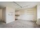 Bright, carpeted living room featuring wall shelves, a kitchen view, and radiant track lighting at 850 20Th St # 203, Boulder, CO 80302