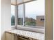 Window view showcasing neighborhood buildings, adding a unique element to this apartment's charm and location at 850 20Th St # 203, Boulder, CO 80302