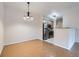 Dining space area with chandelier, wood floors and view of the stainless steel kitchen appliances at 5537 Lewis Ct # 4, Arvada, CO 80002
