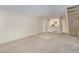 Spacious living area featuring neutral carpeting and a staircase, offering versatile living space at 1915 S Balsam St, Lakewood, CO 80227