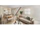 Cozy living room with a staircase, comfortable sofa, chair, and a modern table and wall art at 1915 S Balsam St, Lakewood, CO 80227