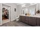 Contemporary bathroom with double vanity, walk-in closet, and tile floors at 20 Wilcox St # 312, Castle Rock, CO 80104